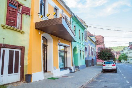 Sighisoara, Romania - August, 2019: Beautiful colorful street in Sighisoara in typical traditional style. This town is the place Dracula is born. Amazing medieval city in the midle of Transylvania.のeditorial素材