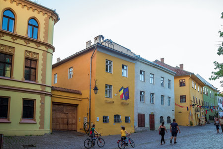 Sighisoara, Romania - August, 2019: Streetlife in center of Sighisoara with typical traditional architectural style. This town is the place Dracula is born. Medieval city in the middle of Transylvaniaのeditorial素材