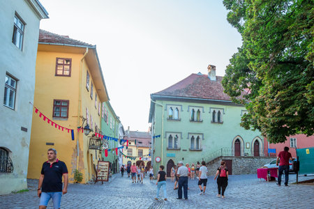 Sighisoara, Romania - August, 2019: Beautiful center of Sighisoara with summer streetlife. This town is the place Dracula is born. Medieval city in the middle of Transylvania. Locals and tourists walkのeditorial素材