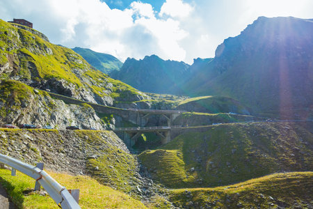 Majestic landscape of summer mountains. View of hills in rays of sunlight. Fagaras Mountains.Transylvania. Romania. Travel backdrop. Amaizing view from down on the Transfagarasan alpine mountain roadの写真素材
