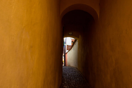 Strada Sforii - the narrowest medieval street in the city of Brasov. It is believed to be one of the narrowest streets in Europe. Transylvania. Brasov is charming town located near the Carpathians.の写真素材