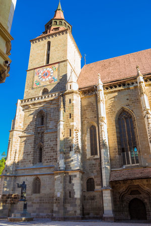 Brasov, Romania - August, 2019: Image of Black Church built in medieval times on Council Square in downtown Brasov, Transylvania. Brasov at summertime. The tower of the saxon Black Church in Romaniaのeditorial素材