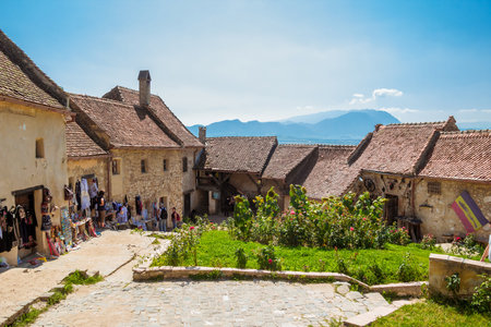 Rasnov, Romania - August, 2019: Inside courtyard, old houses and souvenir shops of The Rasnov Citadel - a medieval fortress in traditional romanian style near the town of Brasov. Transylvaniaのeditorial素材