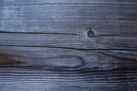 weathered dark wood background with texture. Texture of brown and grey old wood. Wide burned board texture close-up. a wooden surface.の写真素材