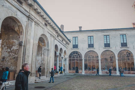 Padernello, Italy - December, 2015: Popular event Mercato della Terra, Earth Market, a farmers market organised in the Padernello Castle. Courtyard of Castello di Padernello with large arched windowsのeditorial素材