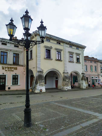Zhovkva, Ukraine - June, 2020: View on Old beautiful buildings and street lantern on The Market square in Zhovkva. Tourism destination, travel. Renaissance-style townhouses. Old town at summer dayのeditorial素材