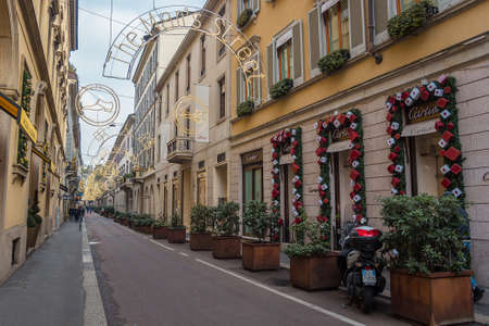 Milan, Italy - December, 2015: Christmas decorated street Via Gesu, called also as the mans street and red decorated Cartier fashion boutique. Concept of luxury, shopping, elegance and made in Italyのeditorial素材