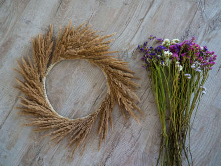 Step 6. Steps of making autumn door wreath from flowers and plants, step by step, tutorial. Florist at work. Creative crafts. Do it yourself. DIY with children home decor.の写真素材
