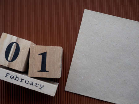 Day 1 of February month, Wooden calendar with date on the brown background. Empty space for text. Greeting card.の写真素材