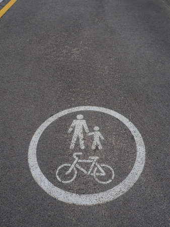 The walking and cycling paths in city with yellow line borders. White road markings for pedestrians...