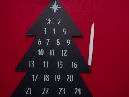 Advent calendar Merry Christmas, drawn in chalk on a blackboard tree shape. Christmas blackboard background with Advent calendar. Countdown calendar to Christmas in chalk on a blackboard.の写真素材