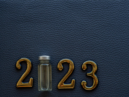 2023, medicine and Vaccination concept. Close up view photo of 2023 and vaccine bottle instead zero...