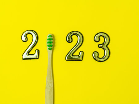 2023 and dental concept. Close up view photo with 2023 and wooden green toothbrush instead zero on...