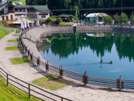 Bukovel, Ukraine - June, 2021: Sights of the modern popular ski resort of Bukovel. Empty Lake in Bukovel in summer. It is the largest ski resort in Eastern Europe situated in West of Ukraine.のeditorial素材