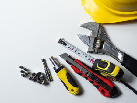 Construction tools, hard hat on white background with copy space. Construction greeting card. For advertising or web design. Repair home. Flat layの写真素材