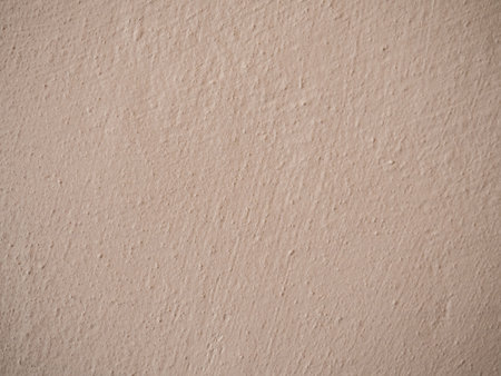 A close up of a beige wall. old textured background with abstract stucco.の写真素材