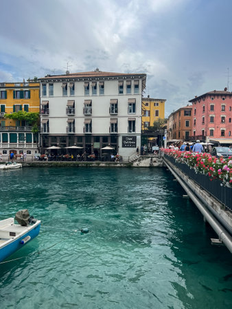 Peschiera del Garda, Italy - June 22, 2024: Landscape of Peschiera del Garda in the province of Verona in Veneto. The main canal in a town on Garda Lake. Sunset view of Canale di Mezzo in Italian townのeditorial素材