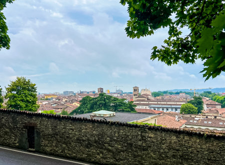 Aerial panoramic view of old historical city centre of Brescia city with churches, towers and medieval buildings with red tiled roofs, Lombardy, Northern Italy. Panorama of Brescia on rainy weather.の写真素材