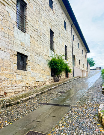 The stone walkway along the walls has a crenellated parapet for defense. Brescia, Italy.の写真素材