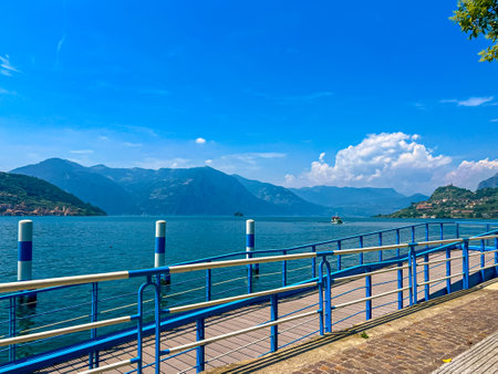 Ferry dock in the town of Sale Marasino on sunny summer day. A small pier along the shore of Lake Iseo, Lombardy, Italy. Touristic boat at Sale Marasino on Iseo Lake in Italyの写真素材