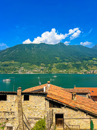 Experience the breathtaking beauty of Carzano, Italy, featuring a panoramic view that showcases the serene Iseo lake nestled among majestic mountains. A perfect blend of nature's splendor.の写真素材