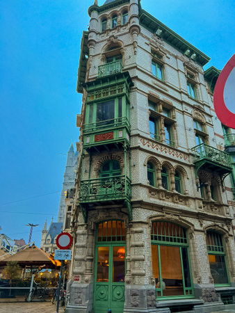 This image showcases a charming art nouveau building located in the center of Ghent. Its beautiful architecture features small towers and large windows, creating an inviting street view. Belgiumの写真素材