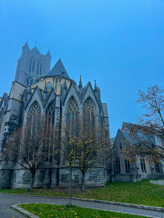 A breathtaking view of the gothic cathedral of Ghent, showcasing its intricate architecture against a stunning azure blue sky. Ideal for travel and architecture enthusiasts. Belgiumの写真素材