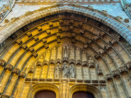 The magnificent front door of Ghent cathedral adorned with intricate carvings, bathed in warm golden light at sunset, creating a stunning visual of this historic architectural masterpiece. Belgiumの写真素材