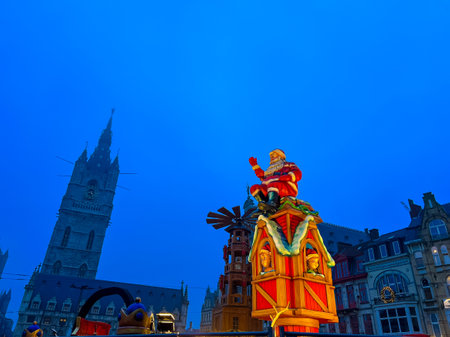 A stunning and vibrant christmas decoration adorns the town hall in Ghent, showcasing a huge, illuminated figure against a clear blue sky, creating a festive atmosphere during the holiday season.の写真素材