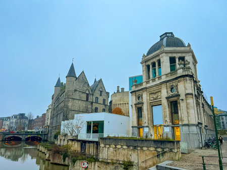 A stunning wide-angle photograph showcasing the intricate details of gothic-style architecture in Ghent, Belgium. The dramatic perspective highlights soaring spires and ornate facades.の写真素材