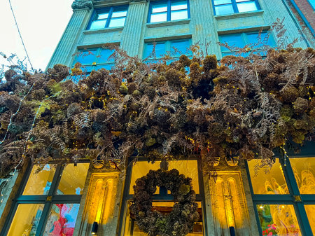 A stunning architectural masterpiece featuring a large arrangement of dried flowers and an elegant art deco window display, showcasing a vibrant blend of nature and design.の写真素材