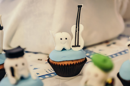 Beautiful cake with musician tooth hero on top for children first tooth party