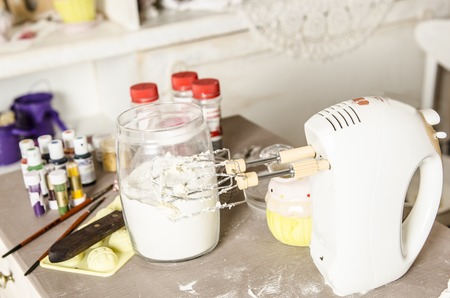 ingredients for dough and kitchen appliances on the tableの写真素材