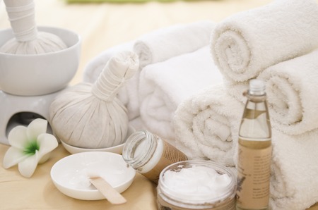 Spa treatment with towels and herbal creams and scrubsの写真素材