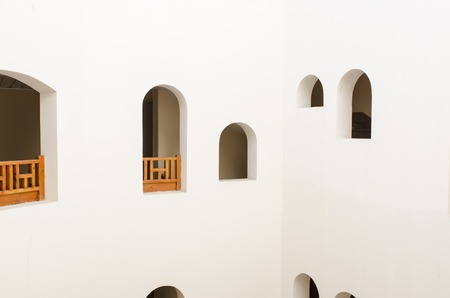 Asian national architecture with small windows and white walls. east culture and architectureの写真素材