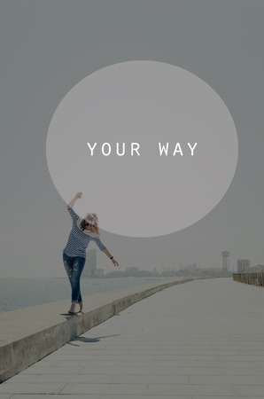 Beautiful young hipster woman walking near sea with raised hands. Oval insert with your way signの写真素材