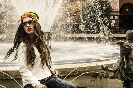 fashionable young woman posing on city streetsの写真素材