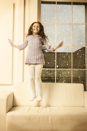 Beautiful happy Lille girl posing in studioの写真素材
