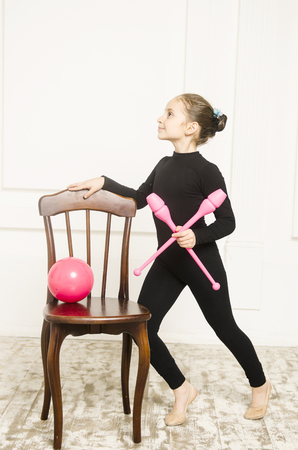 Beautiful sport training rhythmic gymnastic girl posing in studioの写真素材