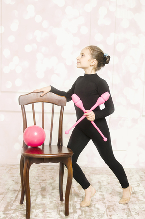 Beautiful sport training rhythmic gymnastic girl posing in studioの写真素材