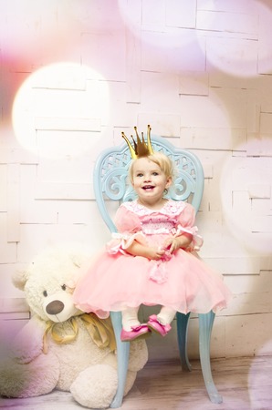 Beautiful happy little princess posing in studioの写真素材