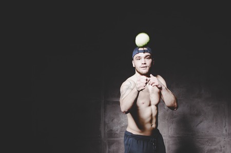 young handsome boxer doing exercises with ballの写真素材