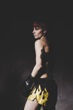 young tattooed woman boxer close up portraitの写真素材
