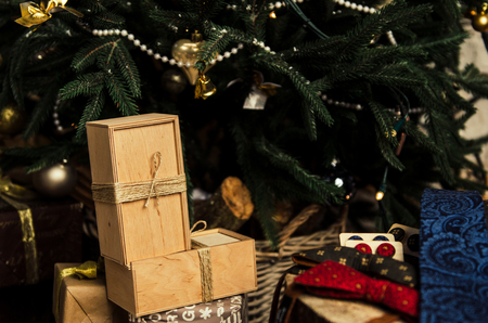 Set of beautiful men accessories of bow tie, neck tie, cufflinks, man's scarf with present box on christmas tree backgroundの写真素材