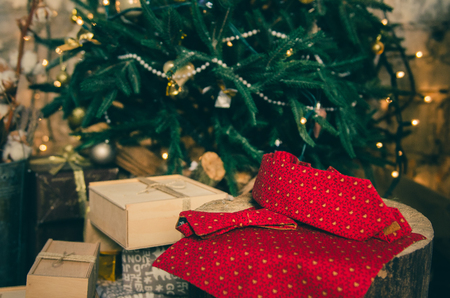Beautiful red polka dot bow tie and neck tie on wooden present boxの写真素材