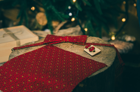 Beautiful red polka dot bow tie and cufflinks on wooden present boxの写真素材