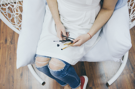 woman stylist holding scissors and brushes, professional toolsの写真素材
