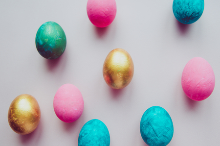 Beautiful colorful easter eggs with confectionery sprinkling on pink background s patternの写真素材