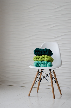 beautiful colorful merino scarf on white chairの写真素材