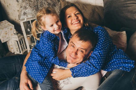 Happy family of father mother and little princess daughterの写真素材